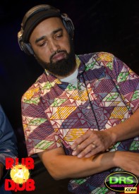 Photo of DJ Passport mixing reggae songs.
